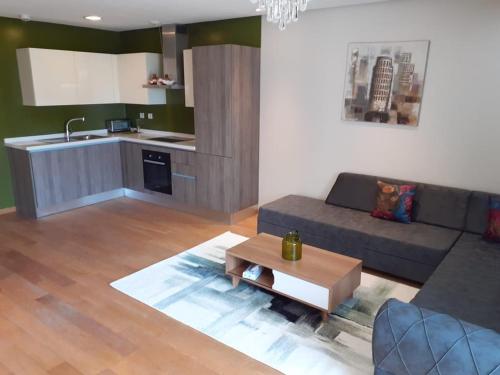 a living room with a couch and a kitchen at Casablanca Marina by Saloua in Casablanca