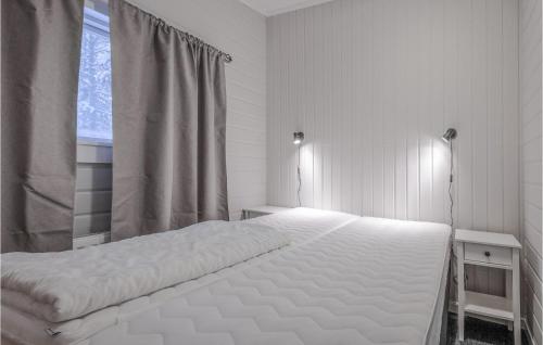 a white bed in a bedroom with a window at Awesome Home In Slen With Sauna And 3 Bedrooms in Sälen