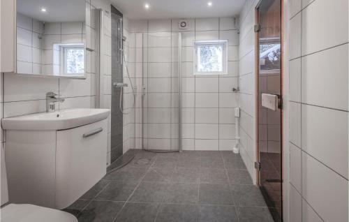a white bathroom with a sink and a shower at Awesome Home In Slen With Sauna And 3 Bedrooms in Sälen