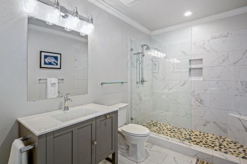 a bathroom with a sink and a toilet and a shower at Harborwalk Lower and Studio in Camden