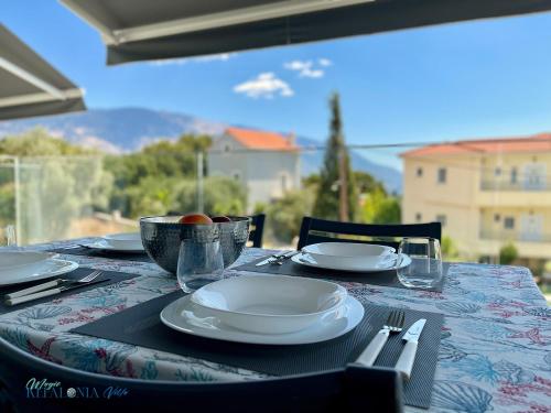 a table with plates and utensils on top of it at Magic Kefalonia Villa in Spartia