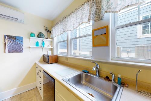 a kitchen with a sink and two windows at Entire House 12 Street OceanBlock in Ocean City