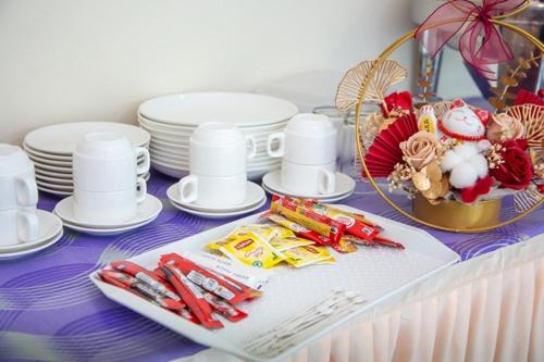 a table with plates and chopsticks on a purple table at Southern Tip Hotel - City & 100m walk to McDonald's & FREE DOBI in Pontian Kecil