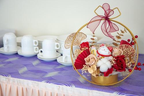 a table with a basket of flowers on a table at Southern Tip Hotel - City & 100m walk to McDonald's & FREE DOBI in Pontian Kecil