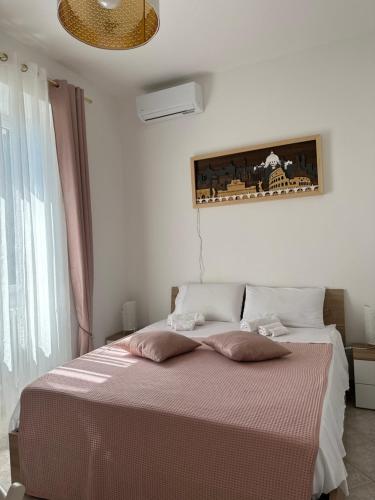 a bedroom with a bed with two pillows on it at Delizioso appartamento San Pietro in Rome