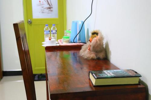 a stuffed animal sitting on top of a wooden desk at Panoramic Royal Villa in Sigiriya