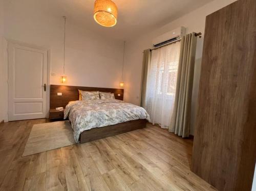 a bedroom with a bed and a wooden floor at 2 bedroom apartement in the center of cairo in Cairo