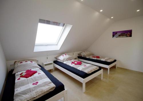 2 camas en una habitación pequeña con ventana en Apartment Hammersbach, en Hammersbach
