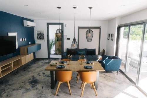 - un salon avec une table et un canapé dans l'établissement PALM VILLAS, à Sainte-Anne