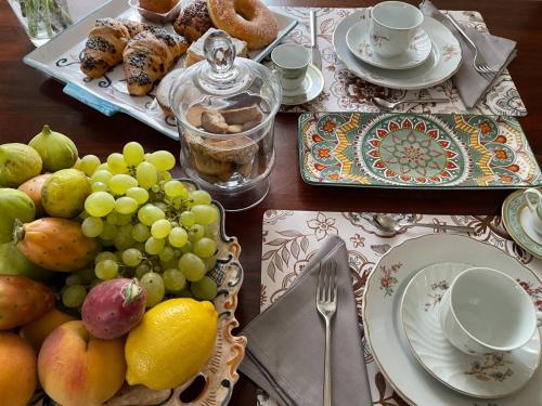 a table topped with plates of fruit and pastries at Sotto le stelle di Capua in Capua