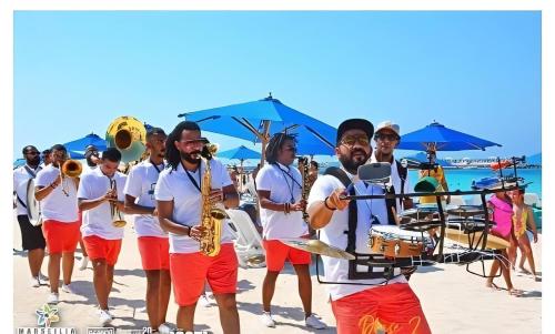 a group of men walking on the beach with instruments at Portosaid بورتو سعيد (غرفه وصاله ) in `Ezbet Shalabi el-Rûdi