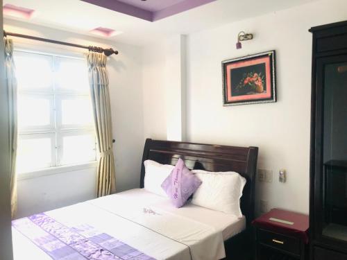 a bedroom with a bed and a window at Huế thương Hotel in Hue