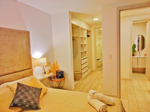 a bedroom with a bed and a hallway at Luxury suite con vista increíble Quito Carolina Coliving Ecuador in Quito