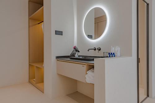 a bathroom with a sink and a mirror at Dali Oriental Seaview Hotel -Dali Erhai in Dali