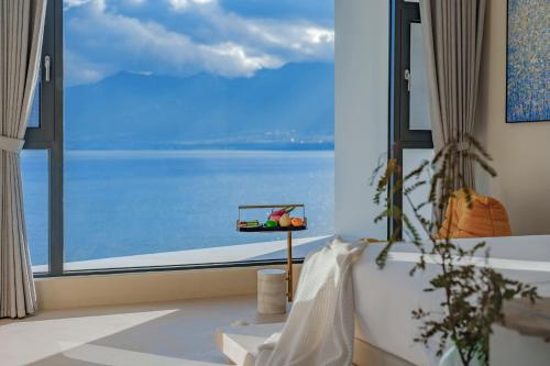 a room with a large window with a view of the ocean at Dali Oriental Seaview Hotel -Dali Erhai in Dali