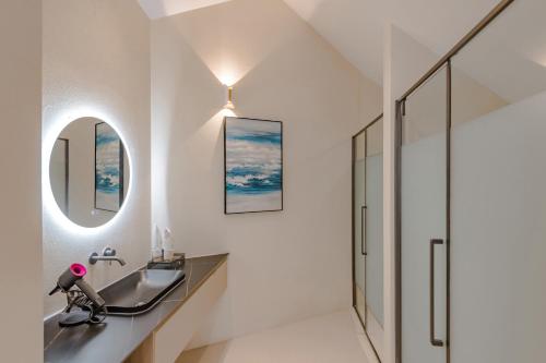 a bathroom with a sink and a mirror at Dali Oriental Seaview Hotel -Dali Erhai in Dali