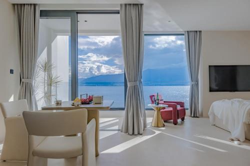 a bedroom with a view of the ocean at Dali Oriental Seaview Hotel -Dali Erhai in Dali