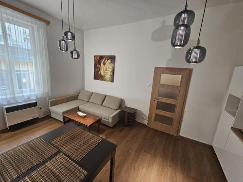 a living room with a couch and a table at Luxury apartment in the heart of Prague in Prague