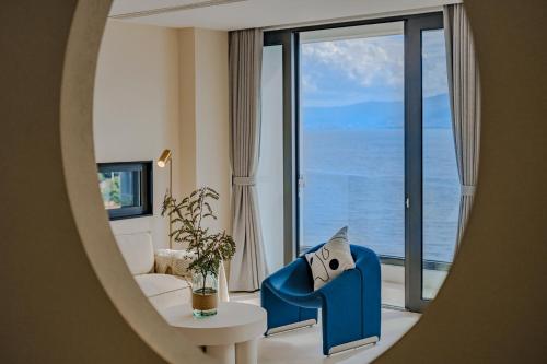 a living room with a view of the ocean at Dali Oriental Seaview Hotel -Dali Erhai in Dali