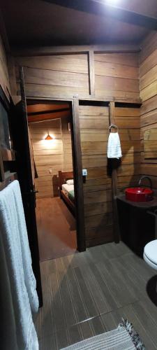 a room with a bathroom with a bed and a sink at Morooka ÁGUA chalé com hidromassagem ALTER CHÃO in Alter do Chao