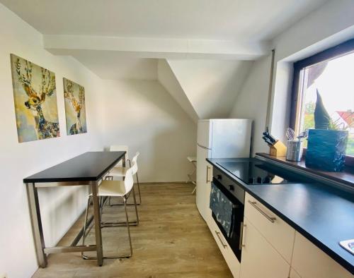 a small kitchen with a table and a refrigerator at Auszeit-Ort mit Wohlfühl-Garantie in Neu-Ulm