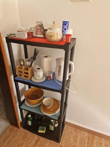 a shelf with plates and utensils on it at Rooms Marijeta in Skradin