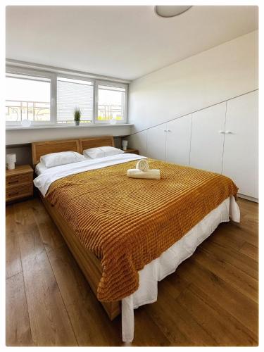 a bedroom with a large bed with a wooden floor at Apartaments in the city centre in Kaunas