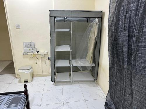 a shower stall in a bathroom with a toilet at Room available in one bedroom appartment dating not allowd thare in Sharjah