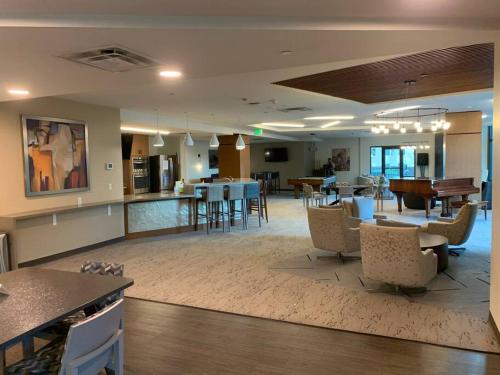 a large lobby with tables and chairs and a bar at 2 BR Condo Heart of LoDo w/Great View/Amenities in Denver