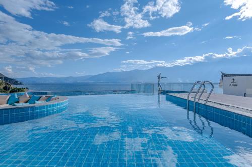 a swimming pool with a view of the ocean at Dali Oriental Seaview Hotel -Dali Erhai in Dali