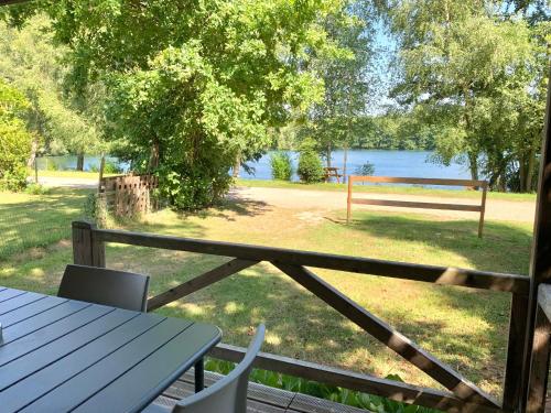 a picnic table with a view of a park at Camping du Château Vert in Hondainville