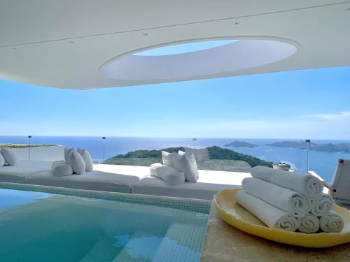 a bedroom with a bed and a swimming pool at Encanto Acapulco in Acapulco