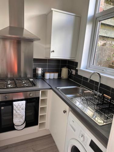 a kitchen with a stove and a sink at Castle Brae Apartment in Stirling