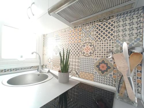a bathroom with a sink and a potted plant at Alicante Alive -Jorge Juan in Alicante