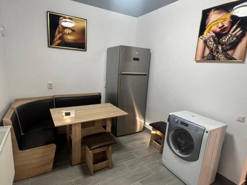 Kleines Zimmer mit einem Tisch und einem Kühlschrank. in der Unterkunft Sipotul Apelor in Domneşti