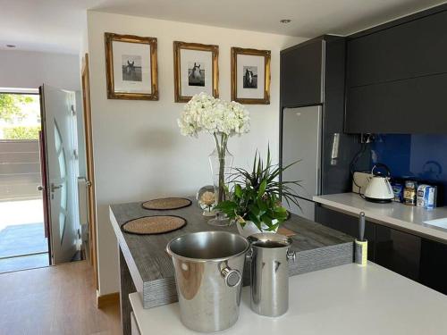 a kitchen with a table with a vase of flowers on it at The pump house hot tub retreat outskirts of leeds in Leeds