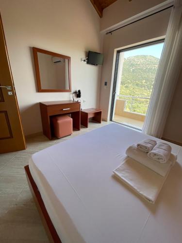 Ένα ή περισσότερα κρεβάτια σε δωμάτιο στο Belvedere Hotel & Suites
