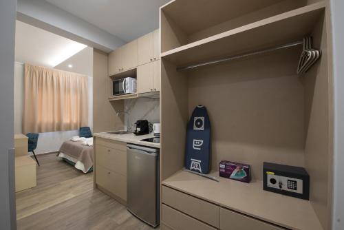 a small kitchen with a stove and a microwave at Rob Venture Suites at the central of ATHENS city in Athens