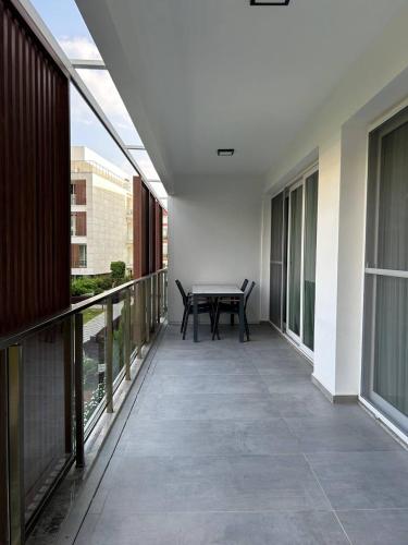 a balcony with a table and chairs on it at Apartment Long Beach in Saint Yeorgios