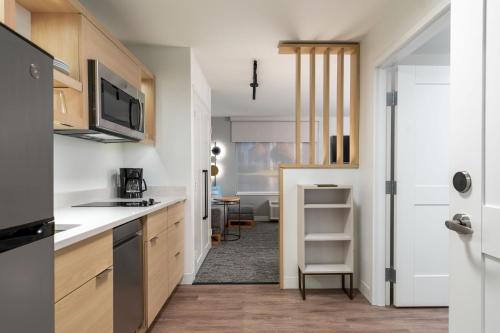 a kitchen with a sink and a microwave at TownePlace Suites by Marriott Canfield in Canfield