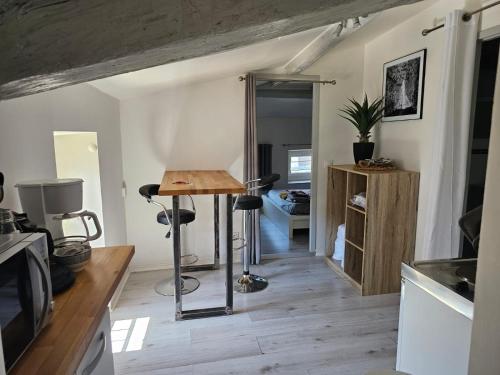 a kitchen with a table in a room at Le Pompéry in Bourg-lès-Valence