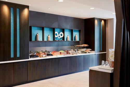a restaurant with a counter with food on it at SpringHill Suites by Marriott Canfield in Canfield