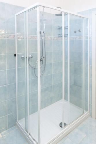 a shower with a glass enclosure in a bathroom at Casa Giovanni XXIII Assisi in Assisi