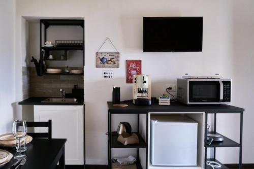 a kitchen with a table with a microwave and a microwave at Eureka Room & Breakfast in Pietrapertosa