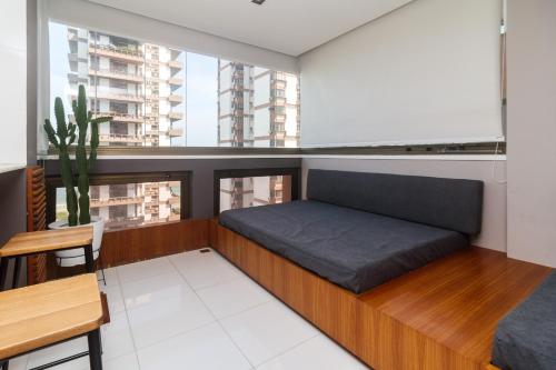 a room with a bed and a large window at Flat Ocean View II in Rio de Janeiro