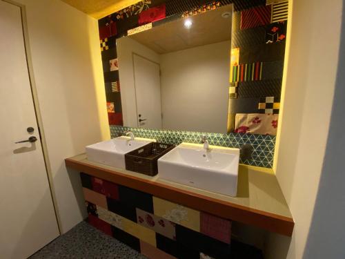 a bathroom with two sinks and a mirror at 日月庵 BnB Sunmoon in Kanazawa