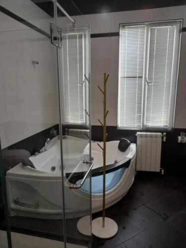 a bathroom with a bath tub with a tree in it at Tskaltubo Apartment Mirian Mepe in Tskaltubo