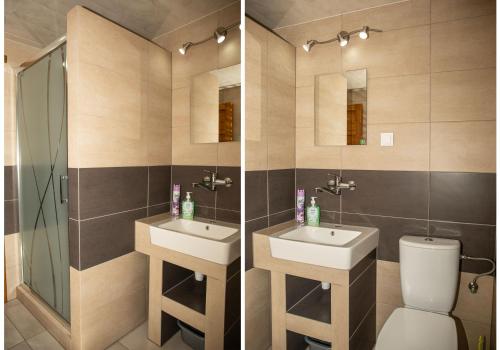 a bathroom with two sinks and a toilet and a mirror at Zielona Plaża in Bereżnica Wyżna