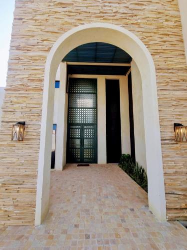 an entrance to a building with a black door at The Gate in Sur