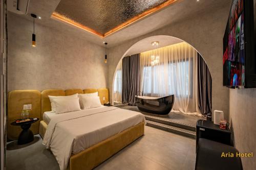 a hotel room with a bed and a tv at Aria Hotel Quận 10 in Ho Chi Minh City